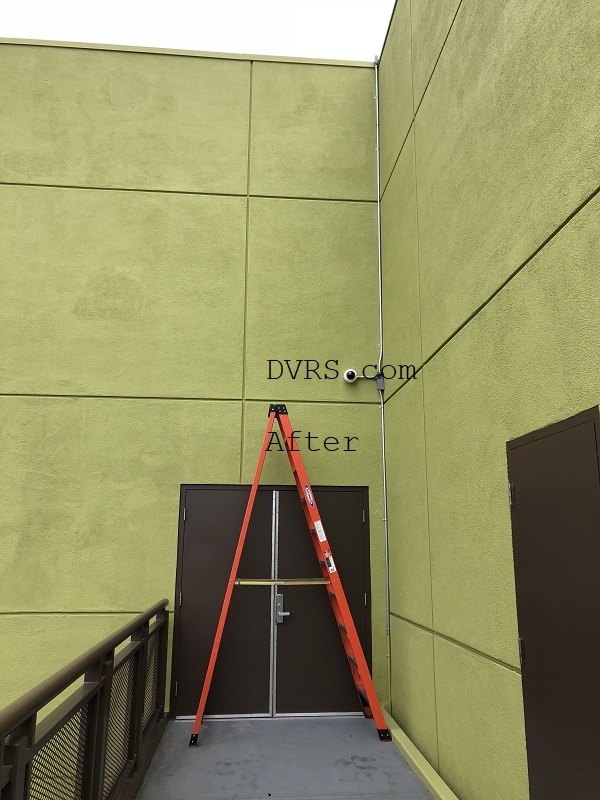 Installing a 4K resolution vandal-resistant dome-style security camera on the second floor of a commercial building requires careful planning and the right equipment. This setup enhances surveillance by providing high-definition footage that captures fine details, even in challenging conditions. The dome design offers a discreet, tamper-proof enclosure to protect against vandalism, making it ideal for public or high-traffic areas. To perform the installation, use a red-colored A-frame ladder for safe access to the elevated position. Position the ladder steadily on a level surface below the mounting spot. Ensure the ladder extends securely to reach the second-floor ceiling or wall without wobbling. Begin by marking the installation point for optimal camera coverage, then secure the mounting bracket firmly. Connect the camera's wiring for power and data transmission, aligning it to cover key entry points or hallways. Test the 4K feed for clarity and adjust angles as needed. This process ensures reliable, long-term security monitoring while prioritizing worker safety.