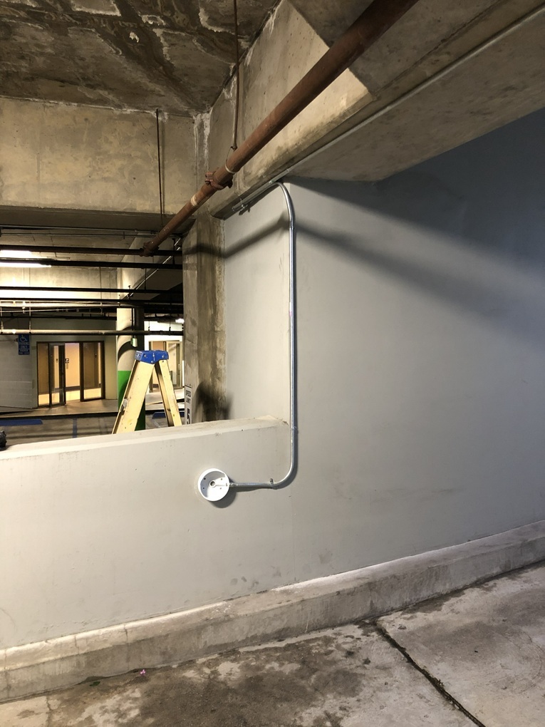 In an underground parking structure, the installation features a single high-definition vandal-resistant dome security camera positioned on the left side for optimal video surveillance coverage. This robust camera is designed to withstand potential tampering or damage in high-traffic environments, ensuring reliable performance and clear footage capture. Equipped with advanced high-def technology, it provides sharp, detailed images to monitor vehicle movements, detect unauthorized access, and enhance overall site security. The dome design offers a discreet yet wide-angle view, minimizing blind spots while integrating seamlessly into the structure's layout. This setup prioritizes durability and efficiency, making it an essential component for protecting assets in subterranean parking facilities.